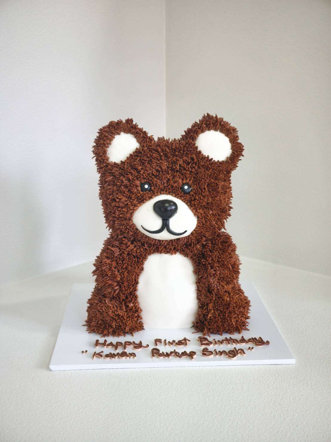 3D teddy bear birthday cake decorated with chocolate piping and fondant face details, perfect for kids' celebrations