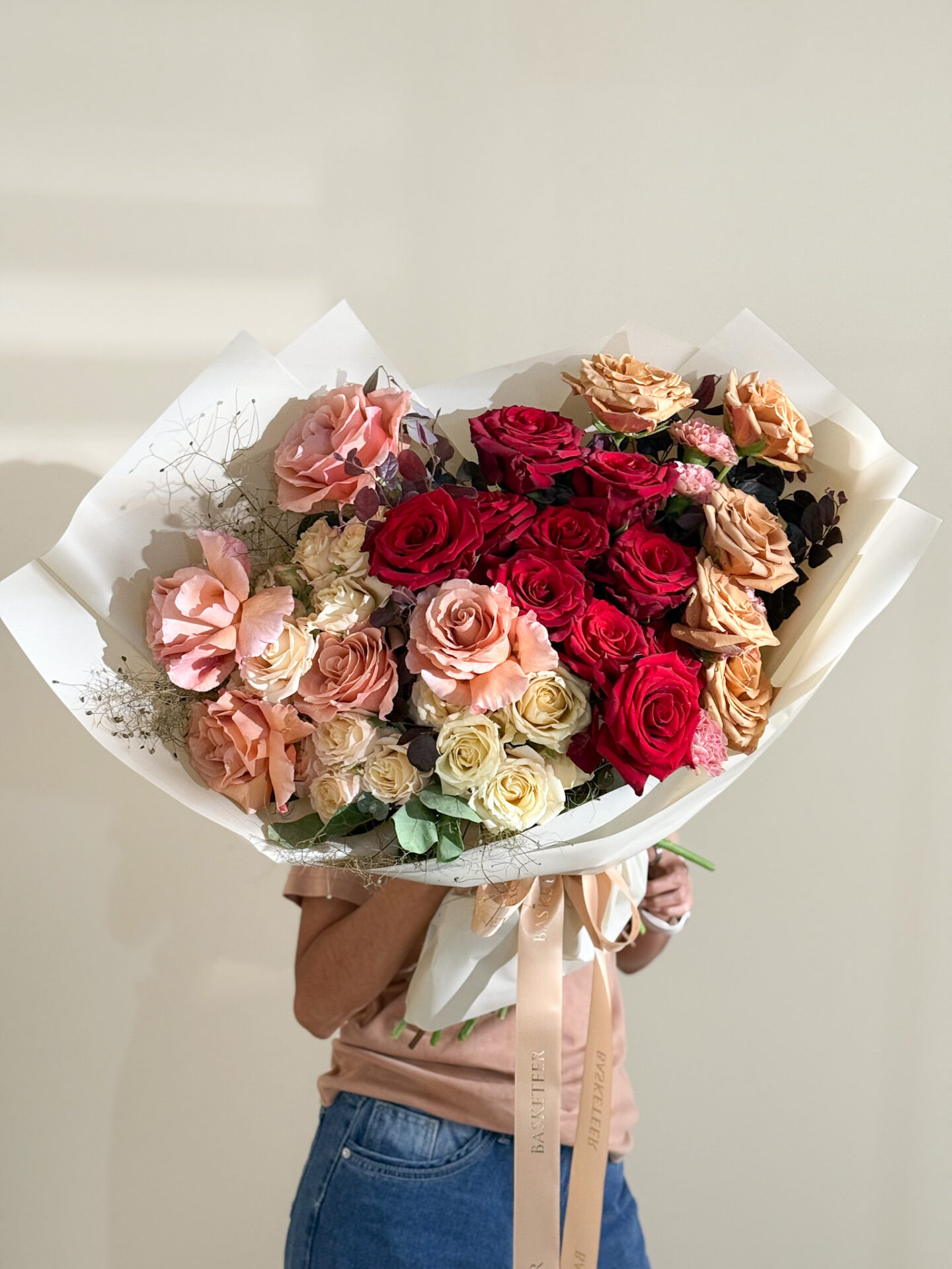 Large luxury rose bouquet featuring red, peach, and champagne roses with elegant wrapping and satin ribbon, designed for premium gifting in Bangkok.