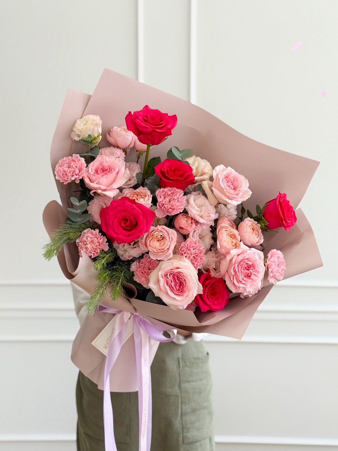 Exquisite Spring Romance Blush Rose Bouquet in pink and red hues, elegantly presented with a lavender ribbon, Bangkok luxury delivery.