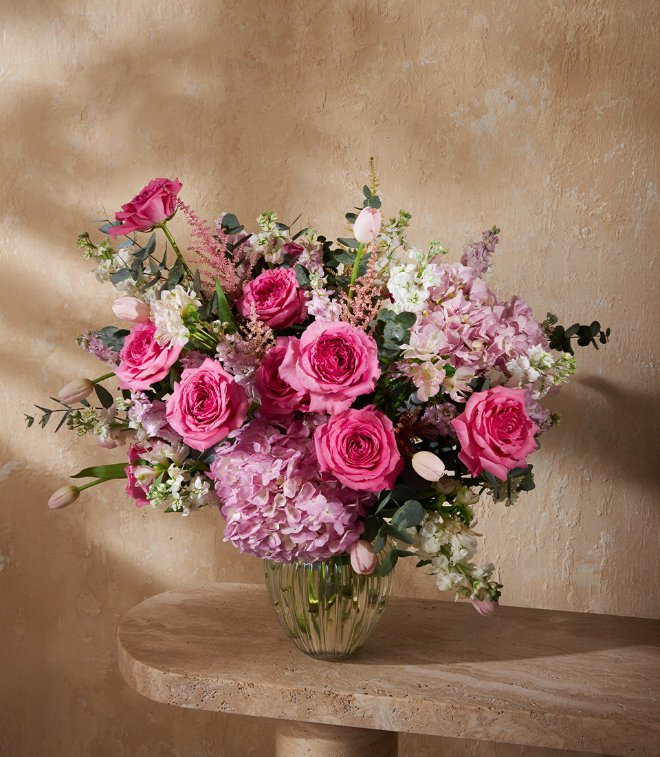 Luxury flower arrangement with pink roses, lilies, hydrangeas, tulips, and astilbe in a modern vase, perfect for Bangkok flower delivery.