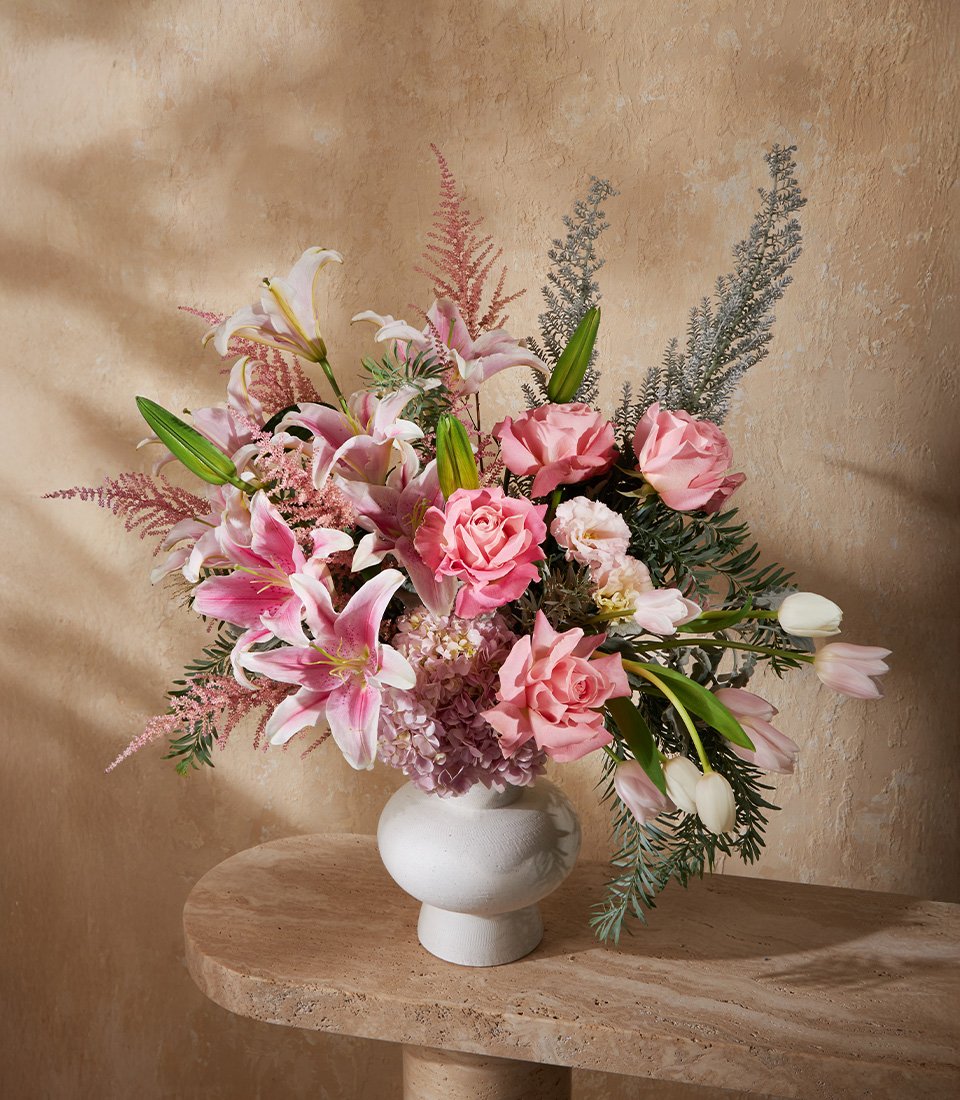 Luxury flower arrangement with pink roses, lilies, hydrangeas, tulips, and astilbe in a modern vase, perfect for Bangkok flower delivery.