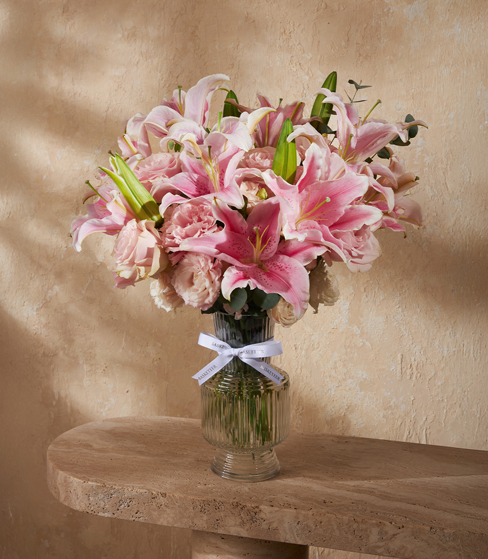 Elegant vase filled with pink lilies and roses, accented with soft blooms and greenery. A luxurious floral gift for Bangkok delivery.
