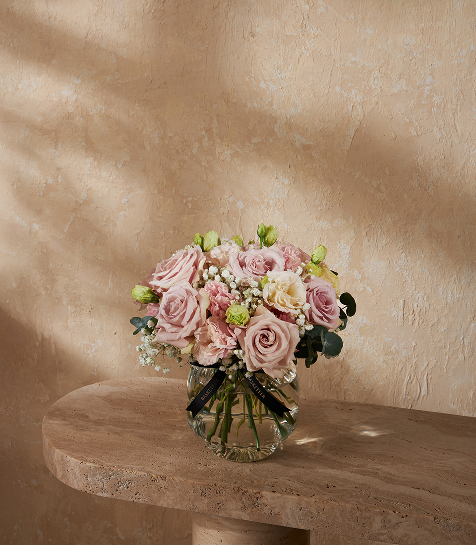 Elegant vase arrangement with pink roses soft cream lisianthus and gypsophila perfect for luxury flower delivery in Bangkok