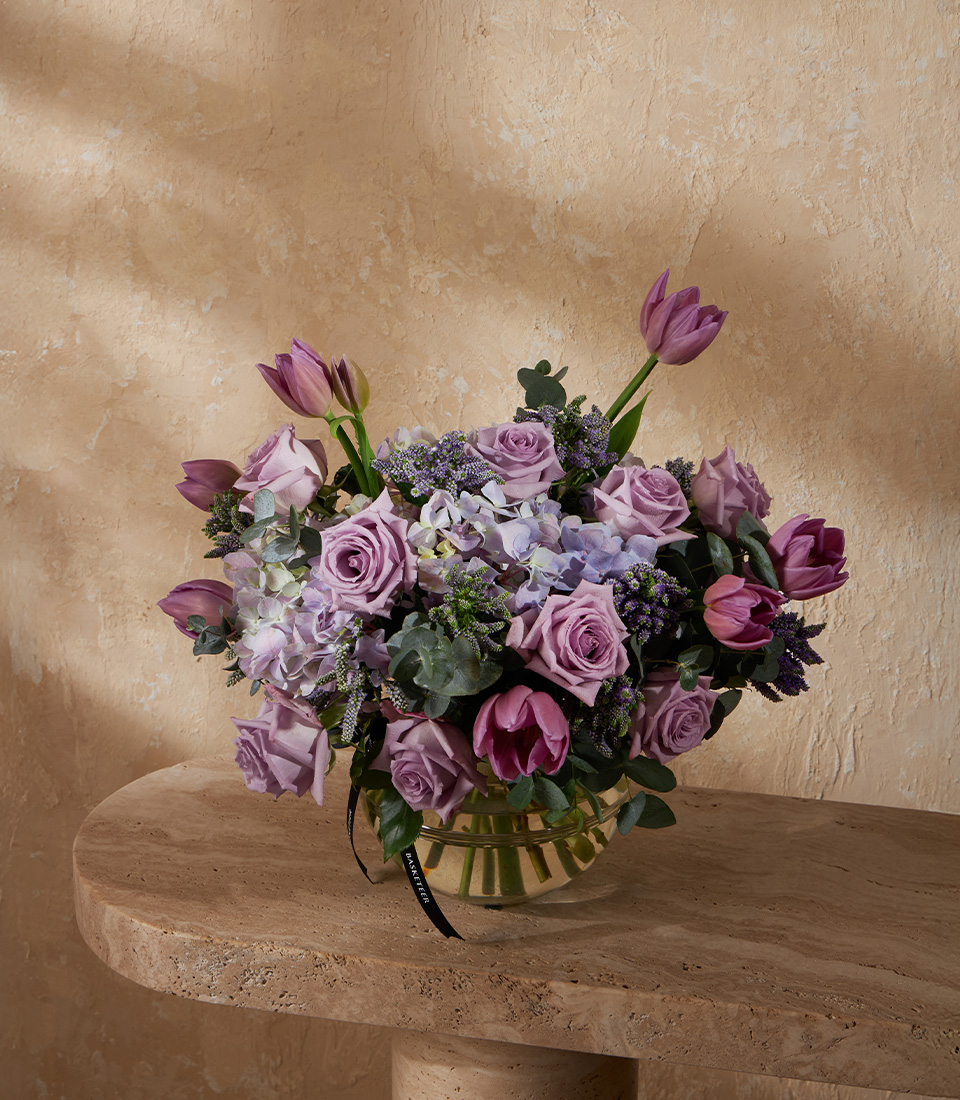 Flower vase arrangement with purple tulips lavender roses and hydrangeas for elegant occasions