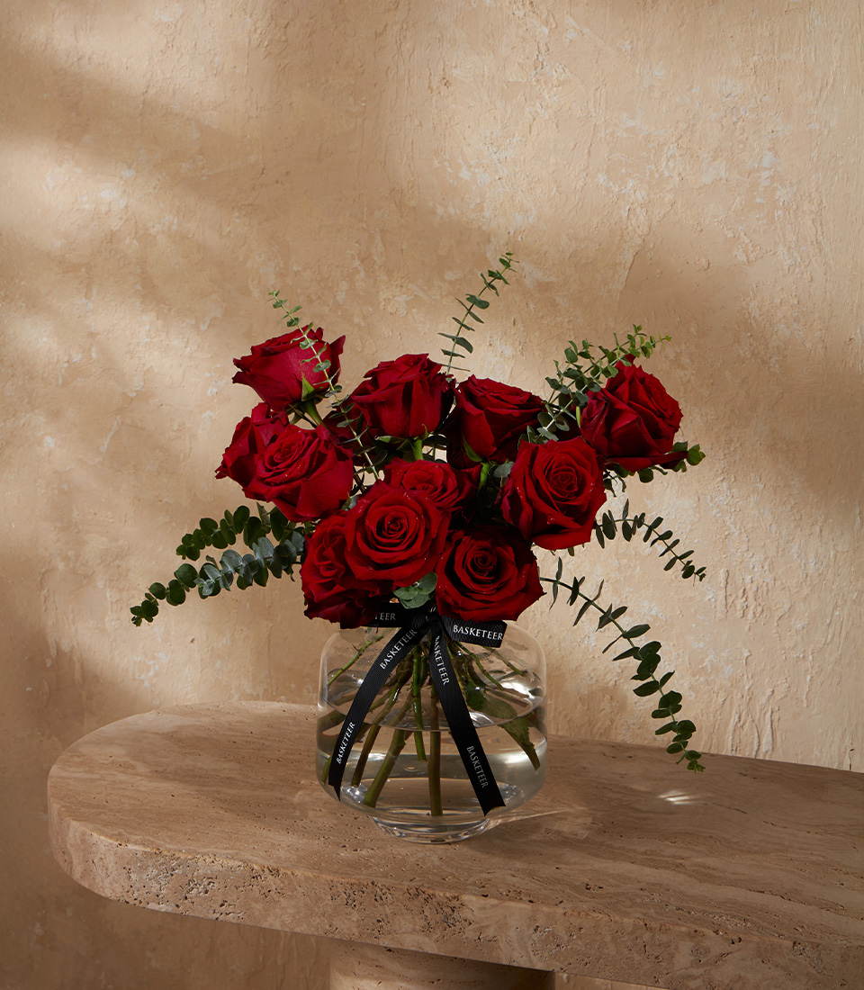 Flower vase arrangement with premium red roses and eucalyptus leaves for romantic occasions