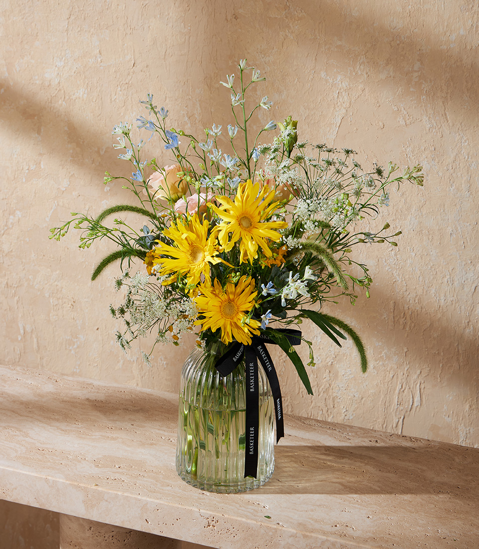 Vase with yellow gerberas pastel flowers and greenery Bright and cheerful floral arrangement for birthdays anniversaries and flower delivery in Bangkok