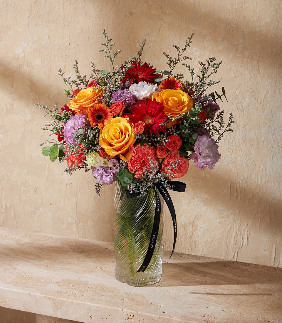 Vase with yellow roses red gerberas purple lisianthus and mixed flowers Bright and elegant arrangement for birthdays anniversaries and Bangkok flower delivery