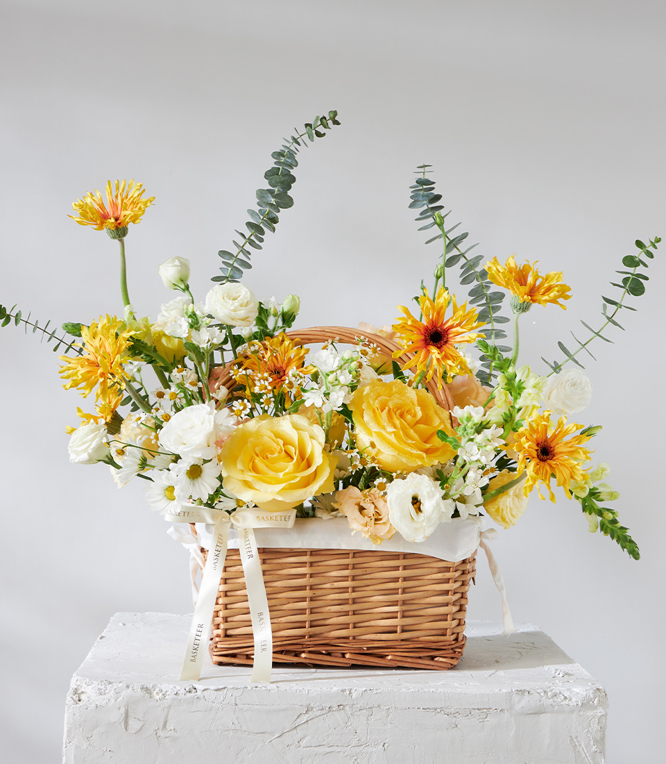 Flower arrangement basket with yellow roses white daisies and seasonal blooms for premium delivery in Bangkok