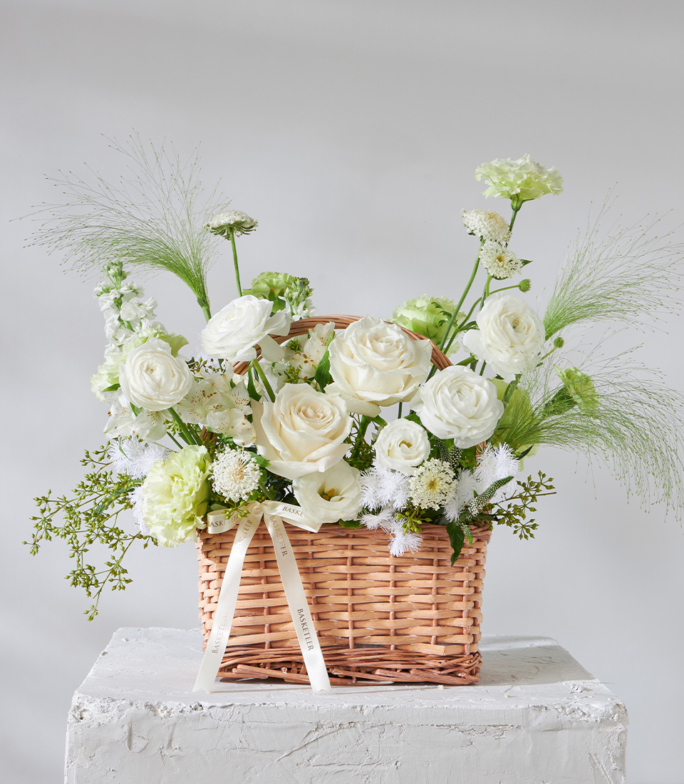 Flower arrangement basket with white roses ranunculus carnations and greenery for premium delivery in Bangkok