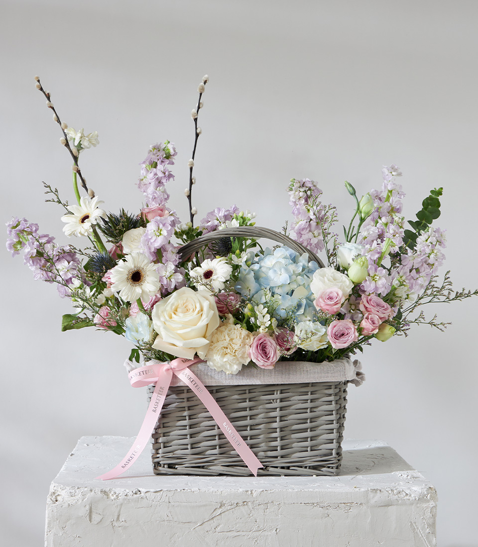 Pastel flower arrangement basket with roses hydrangeas and seasonal blooms for premium delivery in Bangkok