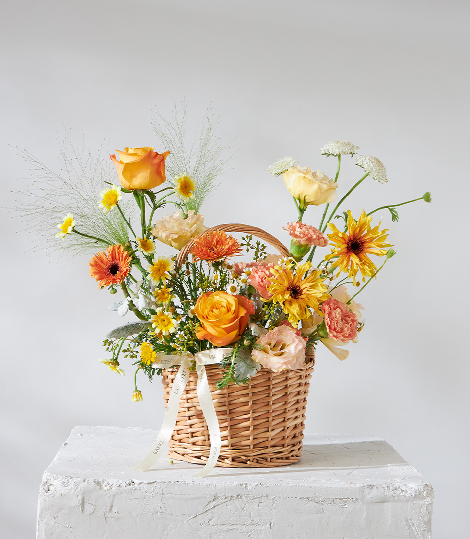Flower arrangement basket with orange roses yellow gerberas carnations and daisies for premium delivery in Bangkok