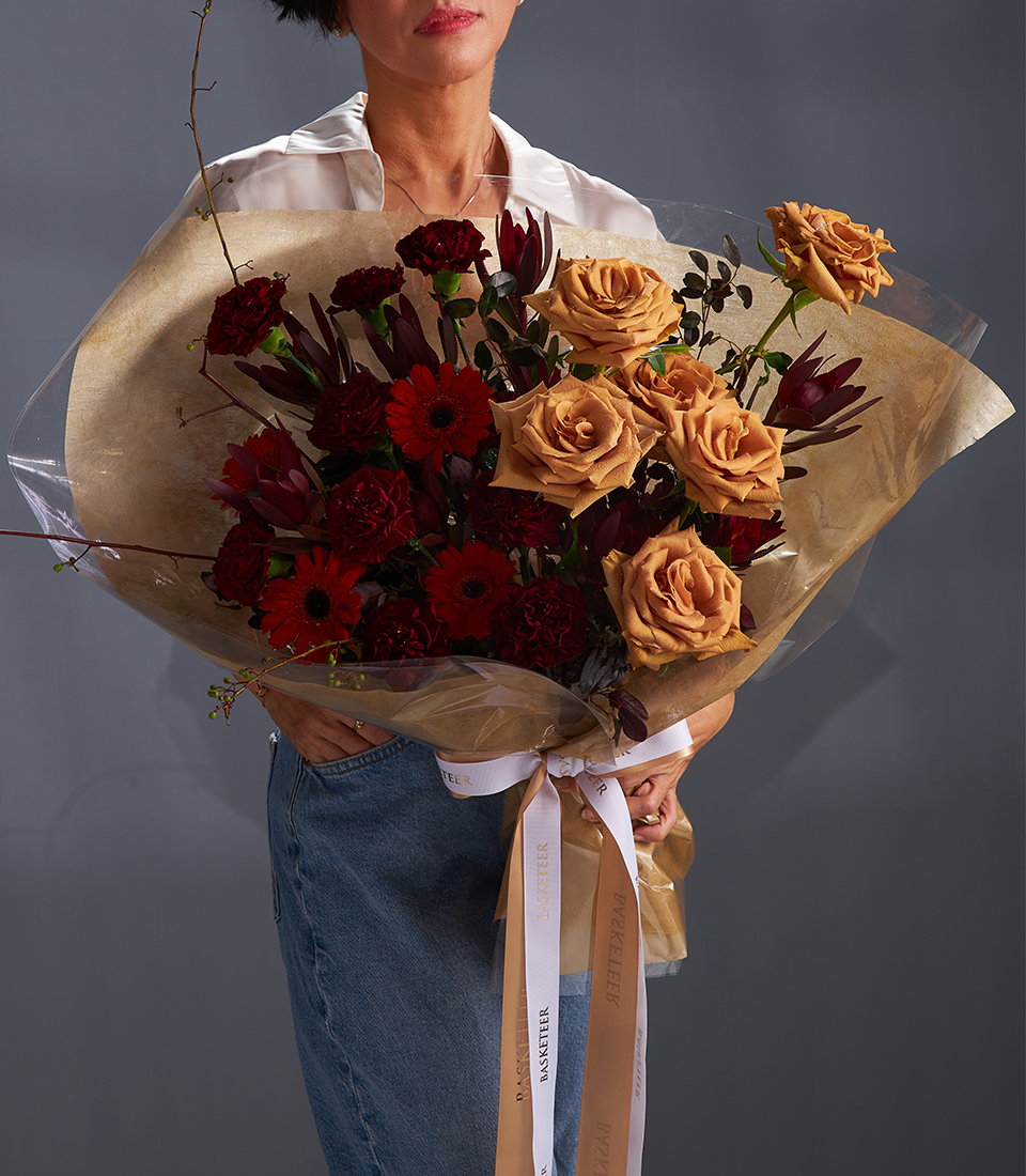 Bouquet of toffee roses burgundy carnations and red gerberas for premium flower delivery in Bangkok