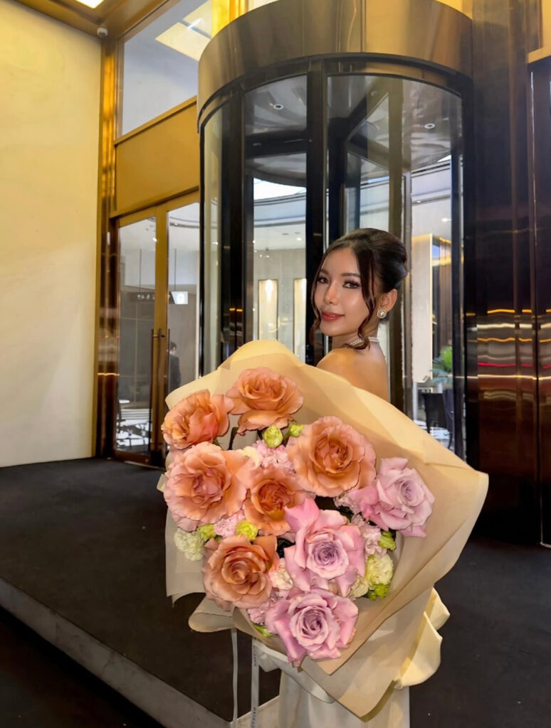Woman holding a peach and lilac bouquet from Flowers by Basketeer
