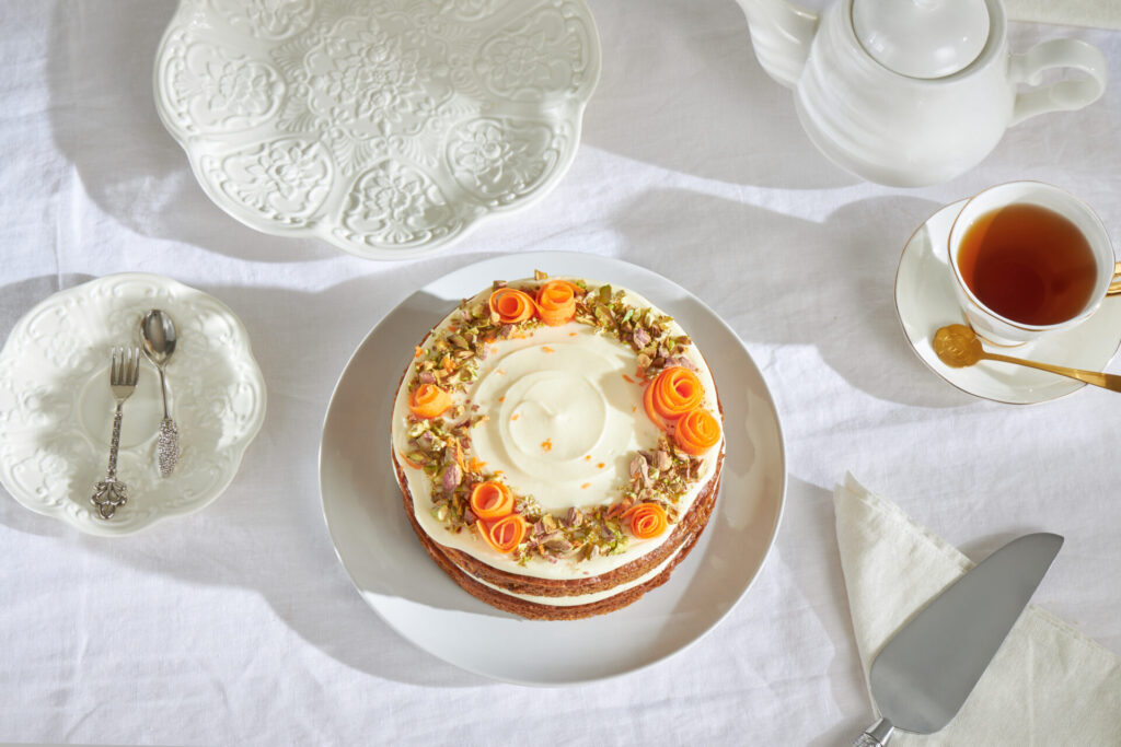 Carrot cake with cream cheese frosting and pistachio topping from Charlotte Bakery Bangkok