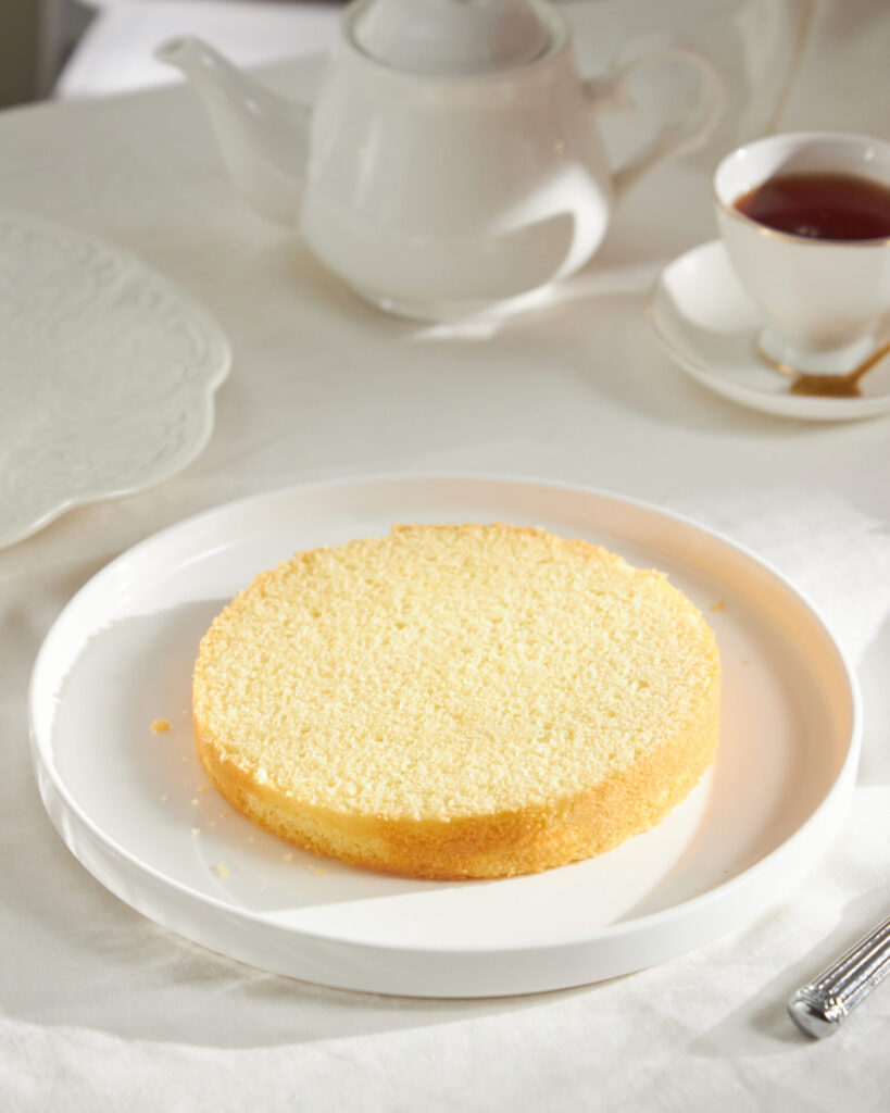 Base layer of sponge cake ready for cream and jam filling at Charlotte Bakery Bangkok