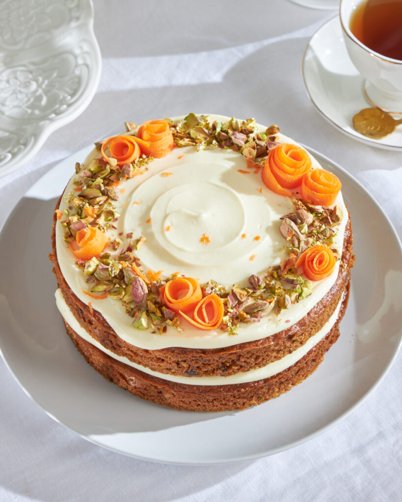 Carrot cake with cream cheese frosting, pistachio, and carrot ribbons from Charlotte Bakery Bangkok
