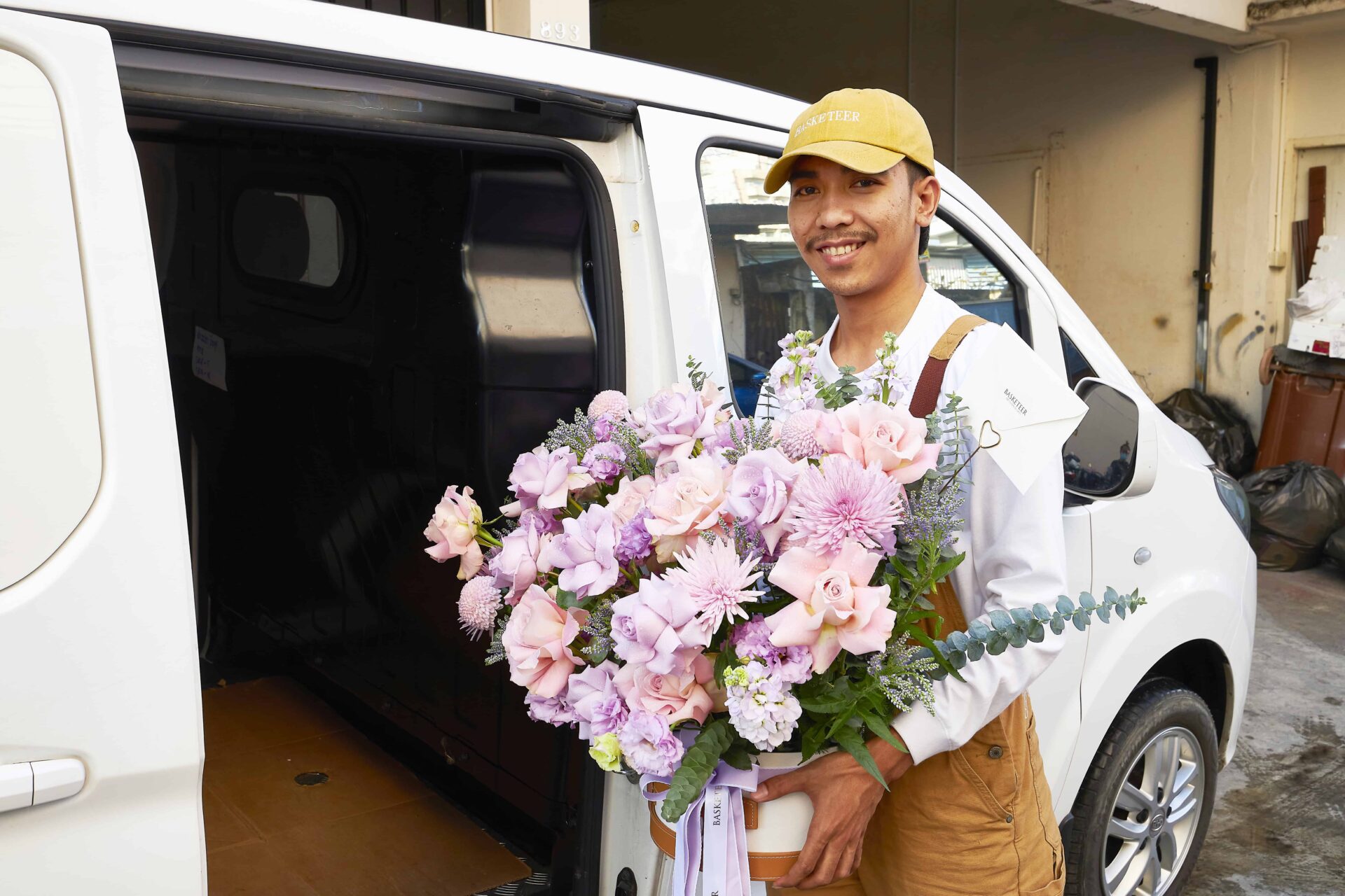 Flowers by Basketeer florist delivering a pastel bouquet in Bangkok using an electric vehicle