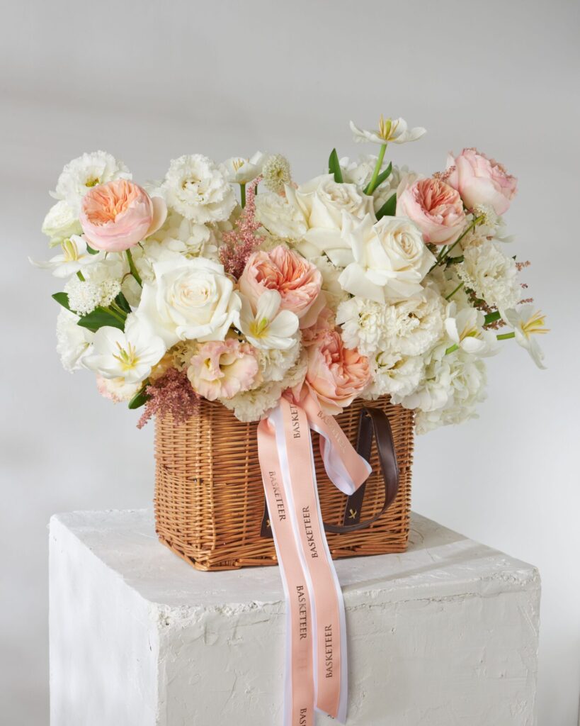 White and peach flower basket from Flowers by Basketeer