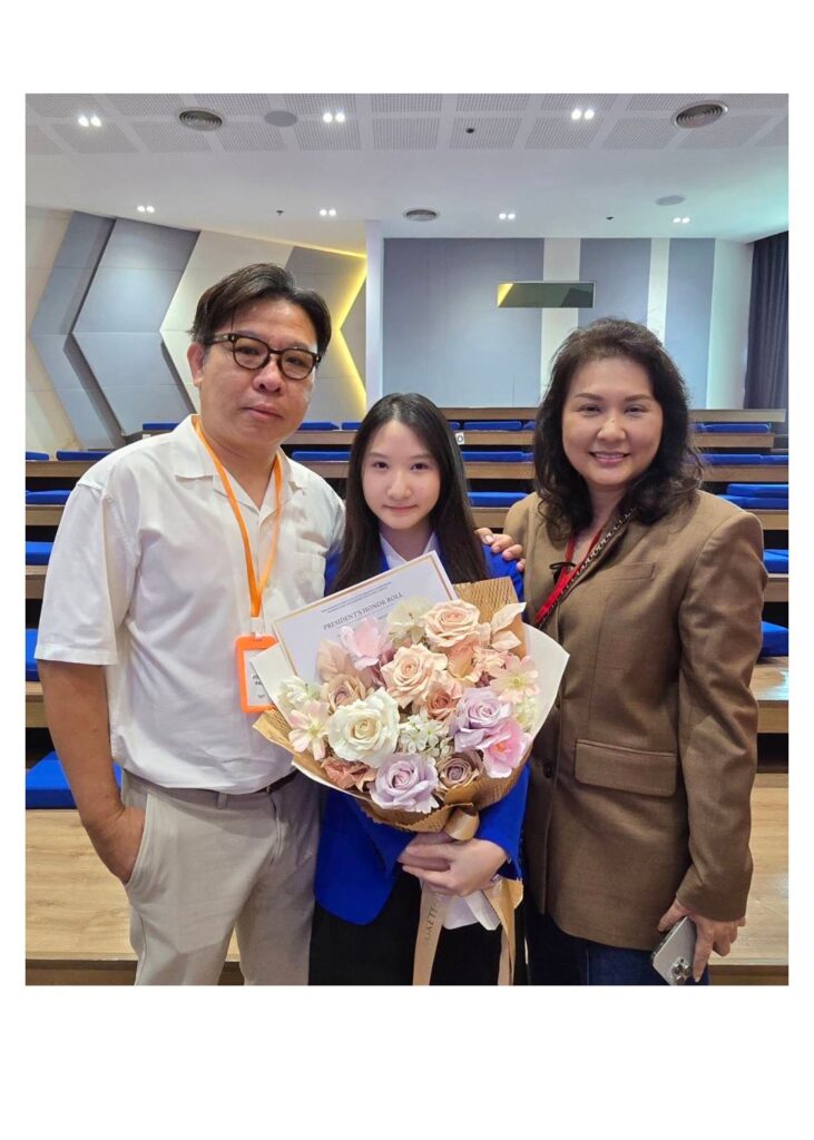 Family posing with a pastel bouquet from Flowers by Basketeer