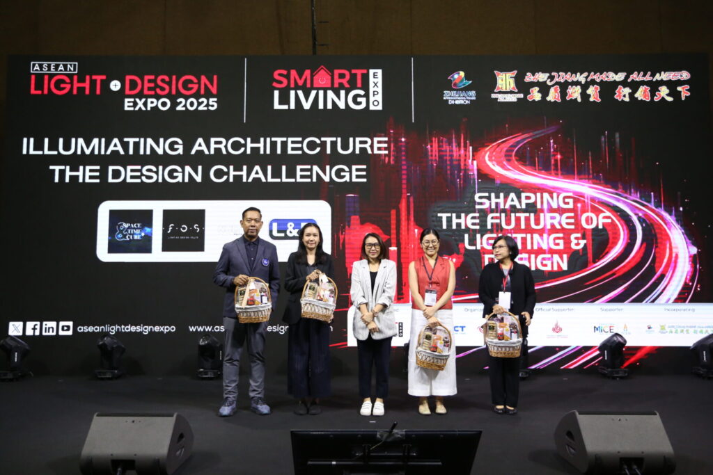 Five people stand on a stage holding gift bags in front of a large display screen with text about the ASEAN Light + Design Expo 2025 and Smart Living Expo. The event theme is “Shaping the Future of Lighting & Design”.