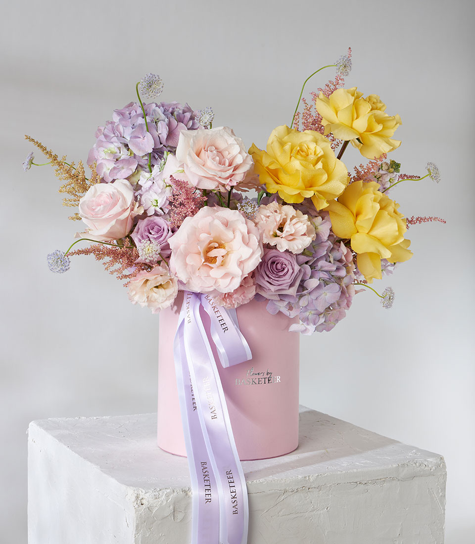 Pastel roses and hydrangeas in pink gift box