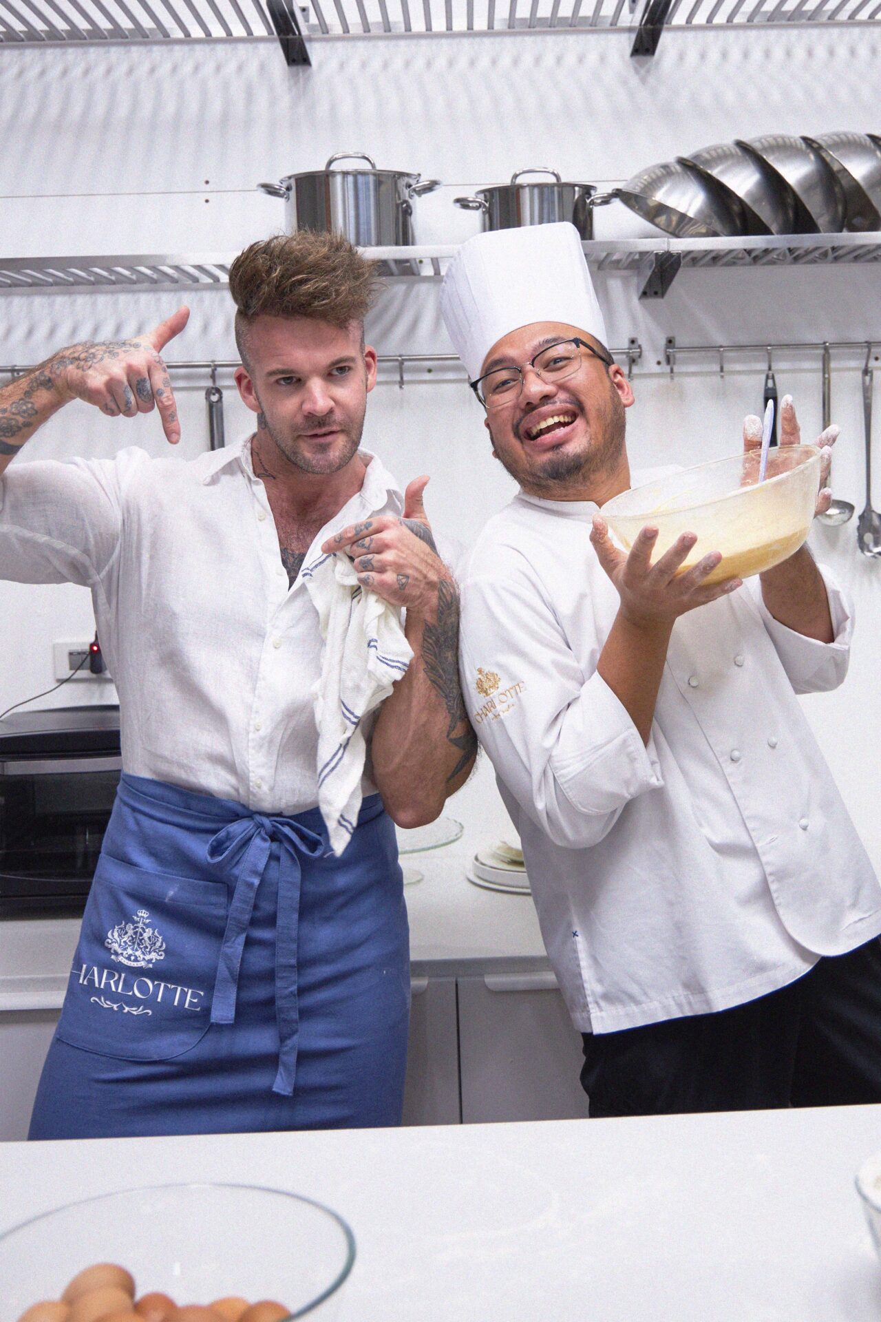 Dan Stoner, founder of Charlotte Bakery Bangkok, and a chef having fun preparing cake batter together at the bakery in Bangkok kitchen
