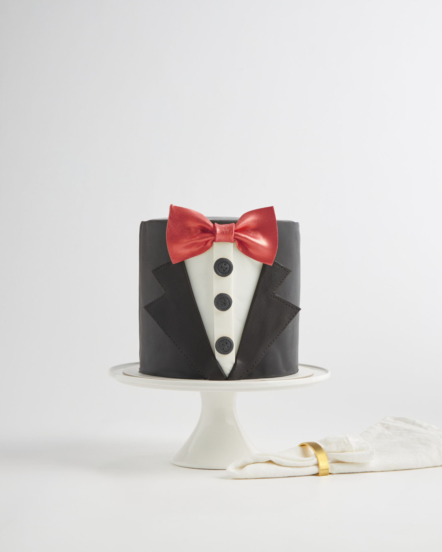 Chocolate tuxedo-style birthday cake with red bowtie design, Charlotte Bakery Bangkok