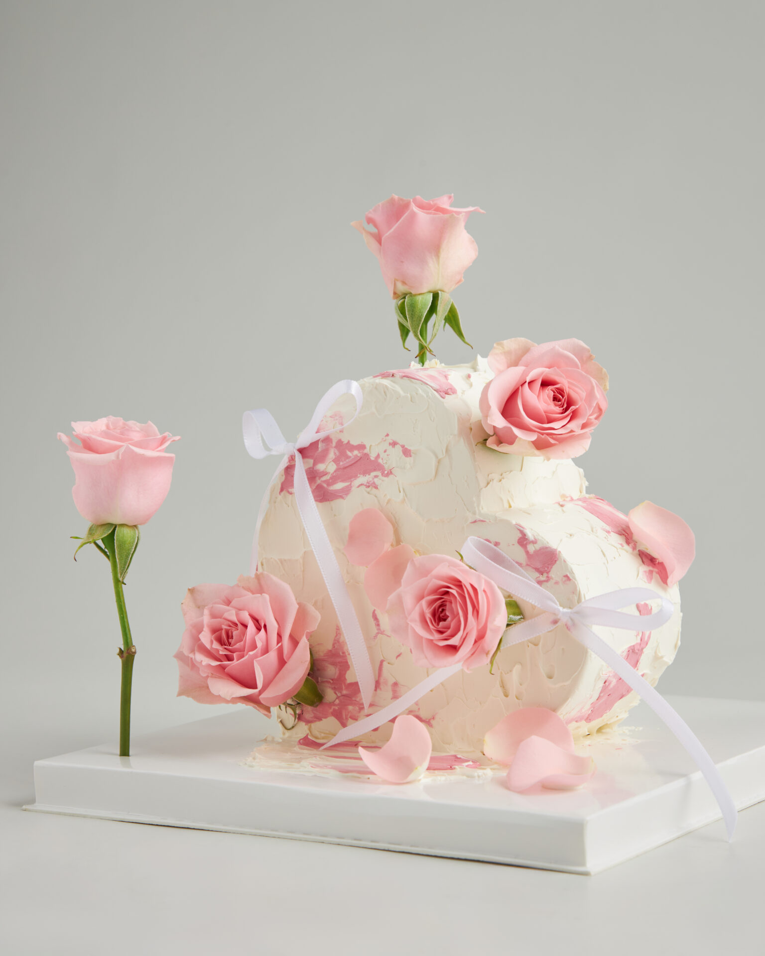 Heart-shaped pink rose birthday cake with delicate frosting and floral design, Charlotte Bakery Bangkok