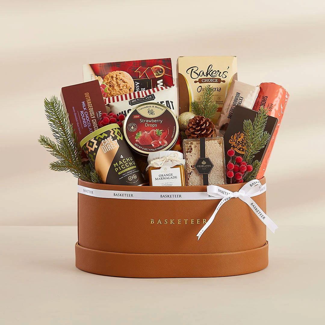 Premium gift basket filled with fine snacks and chocolates in a luxury leather box by Basketeer Thailand