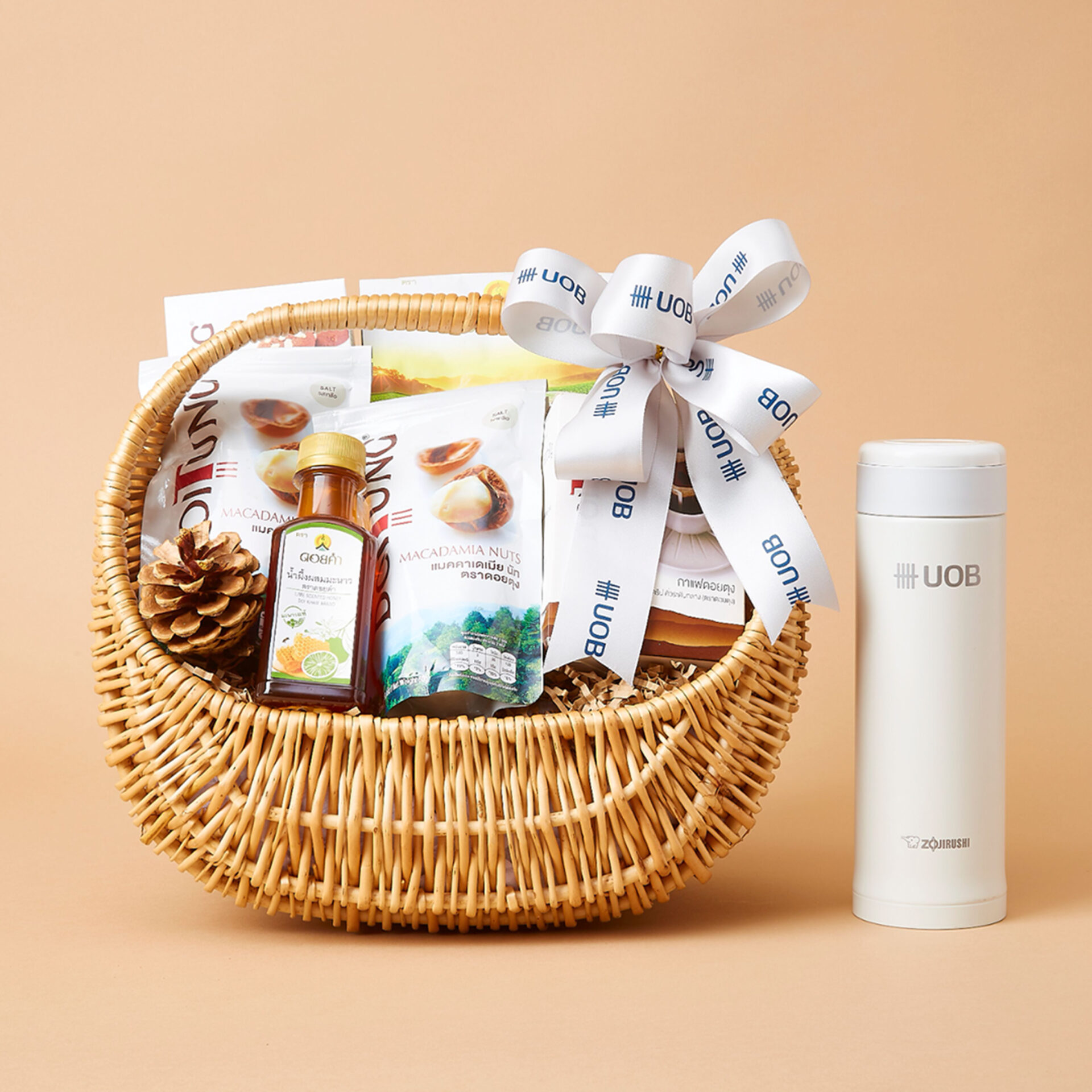 Corporate wicker gift basket with UOB-branded ribbon and premium products by Basketeer Thailand