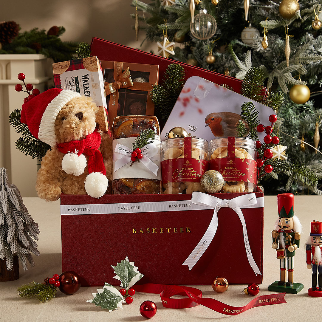 Luxury Christmas gift basket with teddy bear, festive cookies, and holiday treats — beautifully designed by Basketeer Thailand.