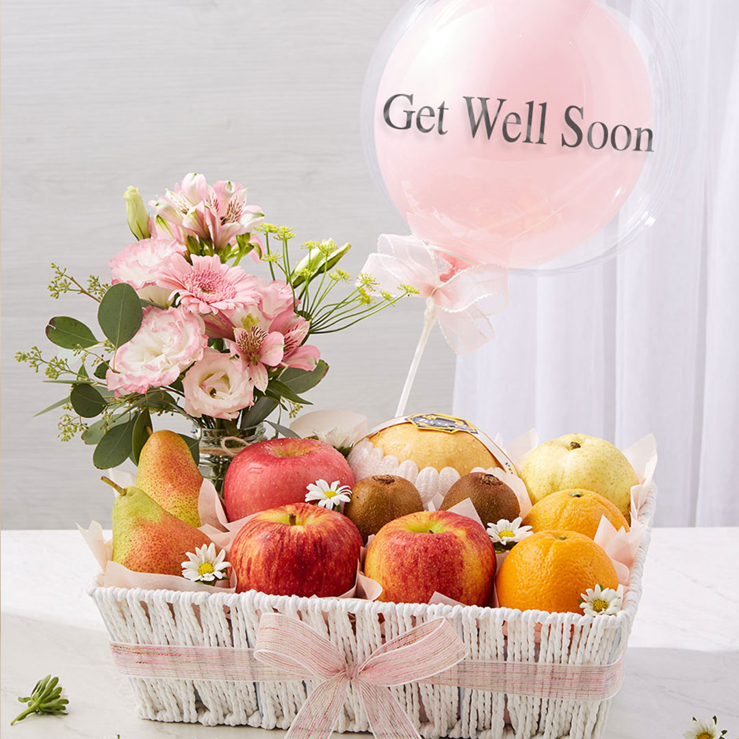 Get Well Soon fruit basket with fresh apples, pears, and oranges, decorated with pink flowers and a balloon by Basketeer Thailand.