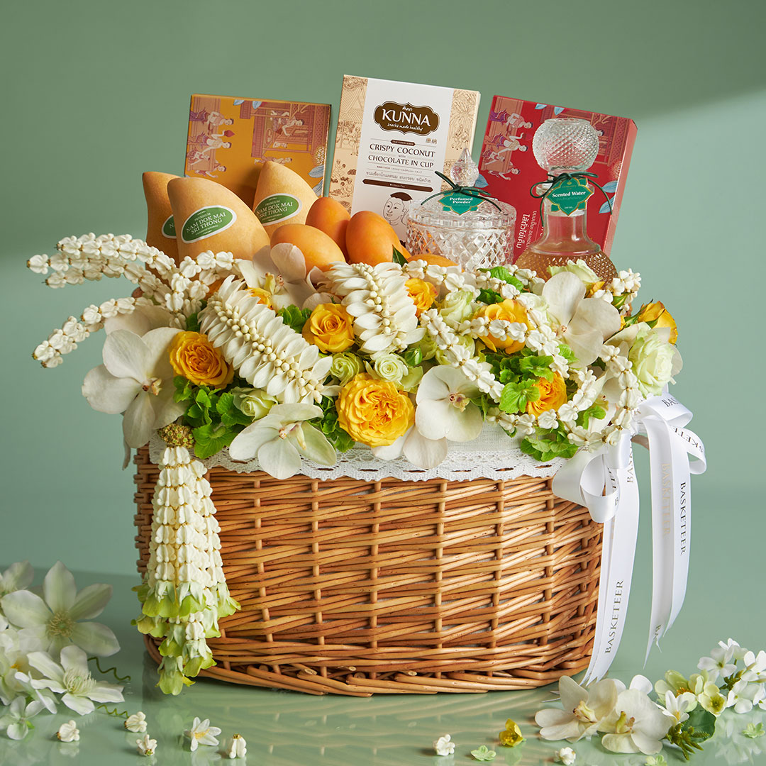 Songkran gift basket decorated with jasmine garlands, Thai sweets, and scented water — designed for gifting elders with respect and blessings.