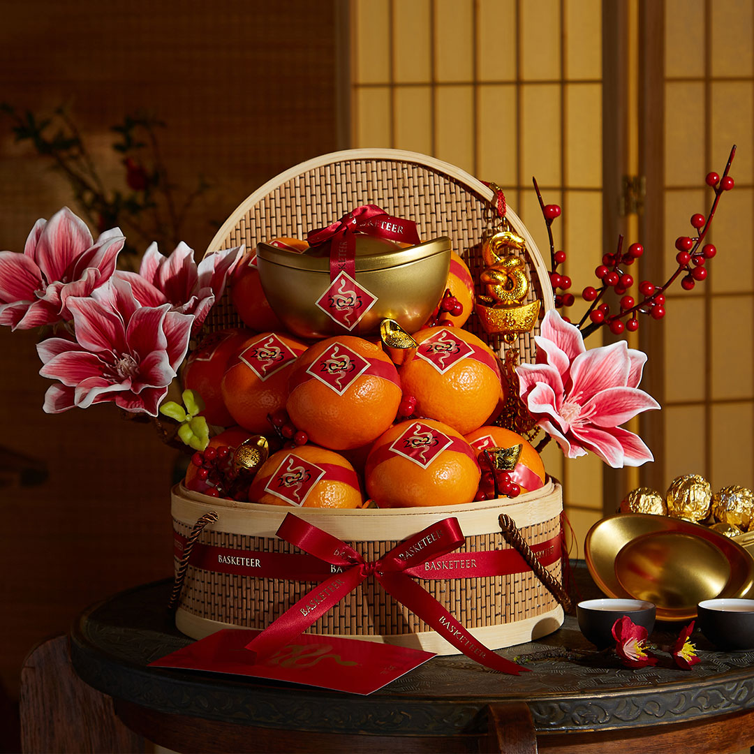 Luxury Chinese New Year gift basket filled with premium mandarin oranges, gold decorations, and red accents — symbolizing prosperity and good fortune.