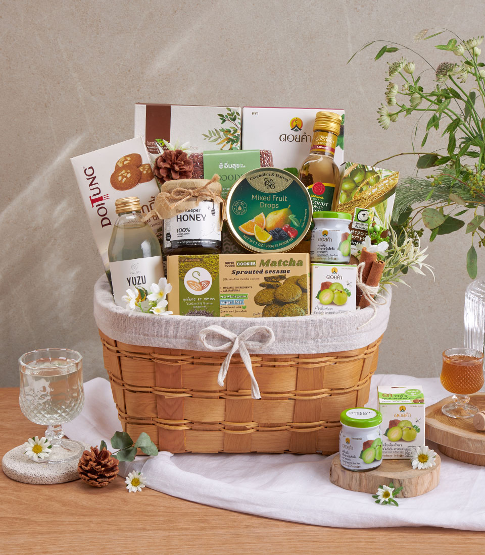 Full view of organic gourmet & thai set basket with assorted snacks and drinks in a woven basket.