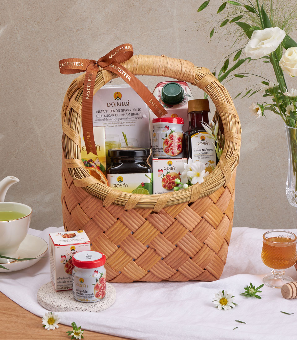 Full view of doi kham herbal & honey basket with assorted snacks and drinks in a woven basket.