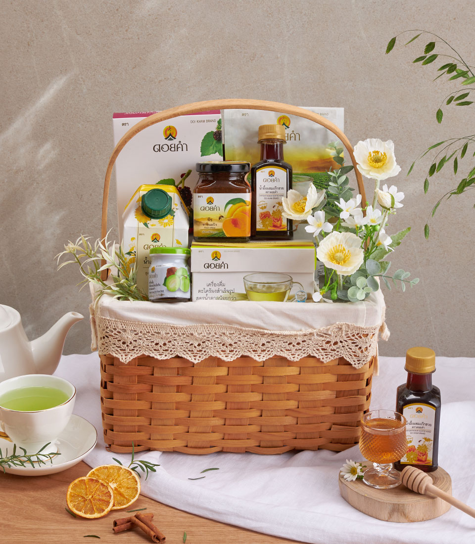 Full view of doi kham wellness gift basket with assorted snacks and drinks in a woven basket.