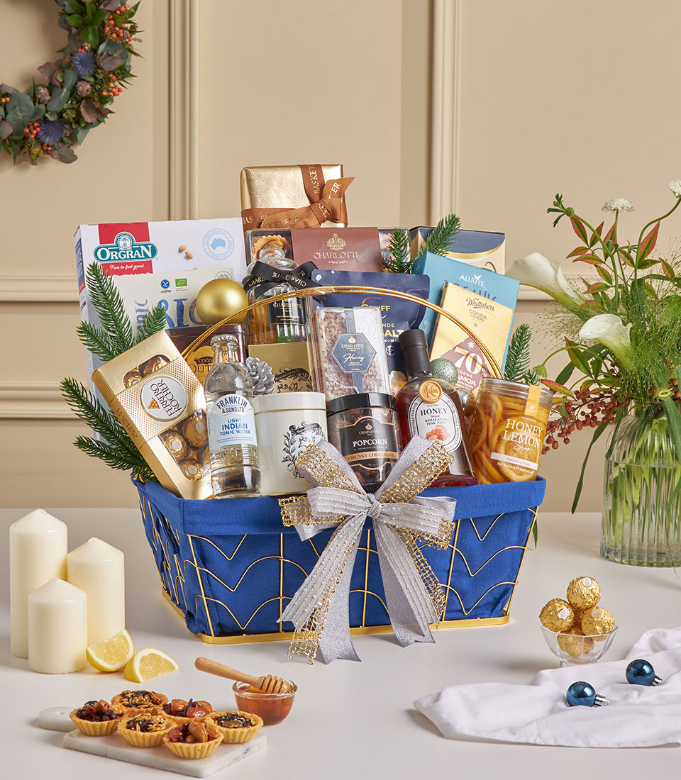 Blue luxury gourmet gift basket with premium cookies, chocolates, and festive gold ribbon.