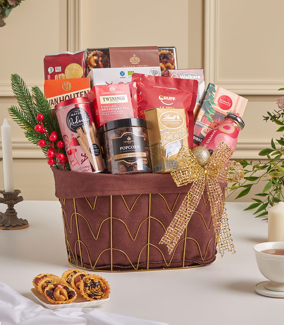 Brown gourmet gift basket with assorted snacks, chocolates, and beverages.