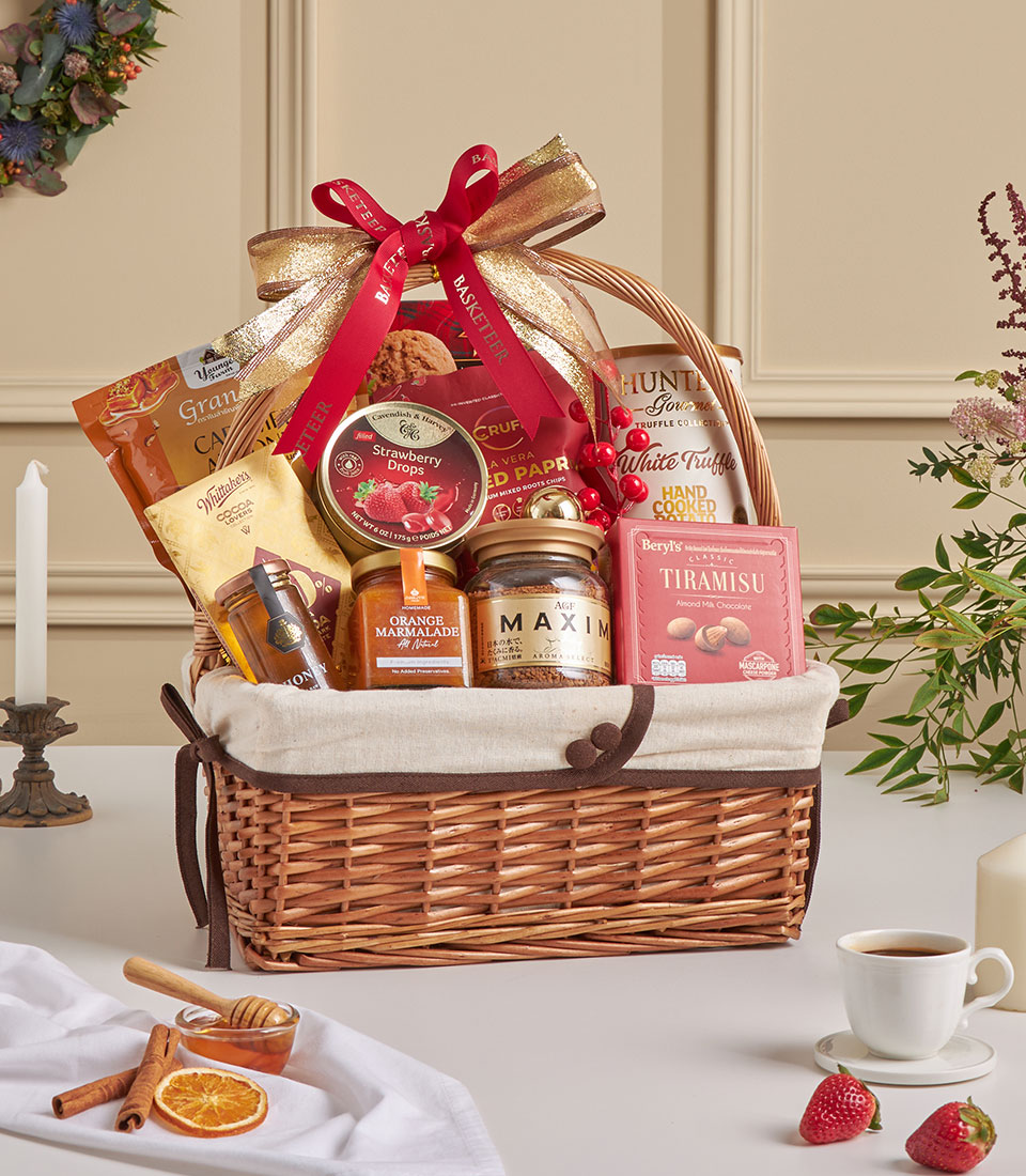 Golden holiday gourmet gift basket with cookies, jam, coffee and festive treats.