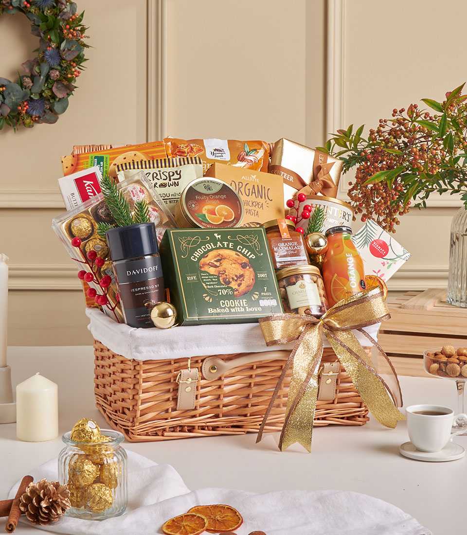 Luxury orange gourmet gift basket with chocolates and fine snacks.