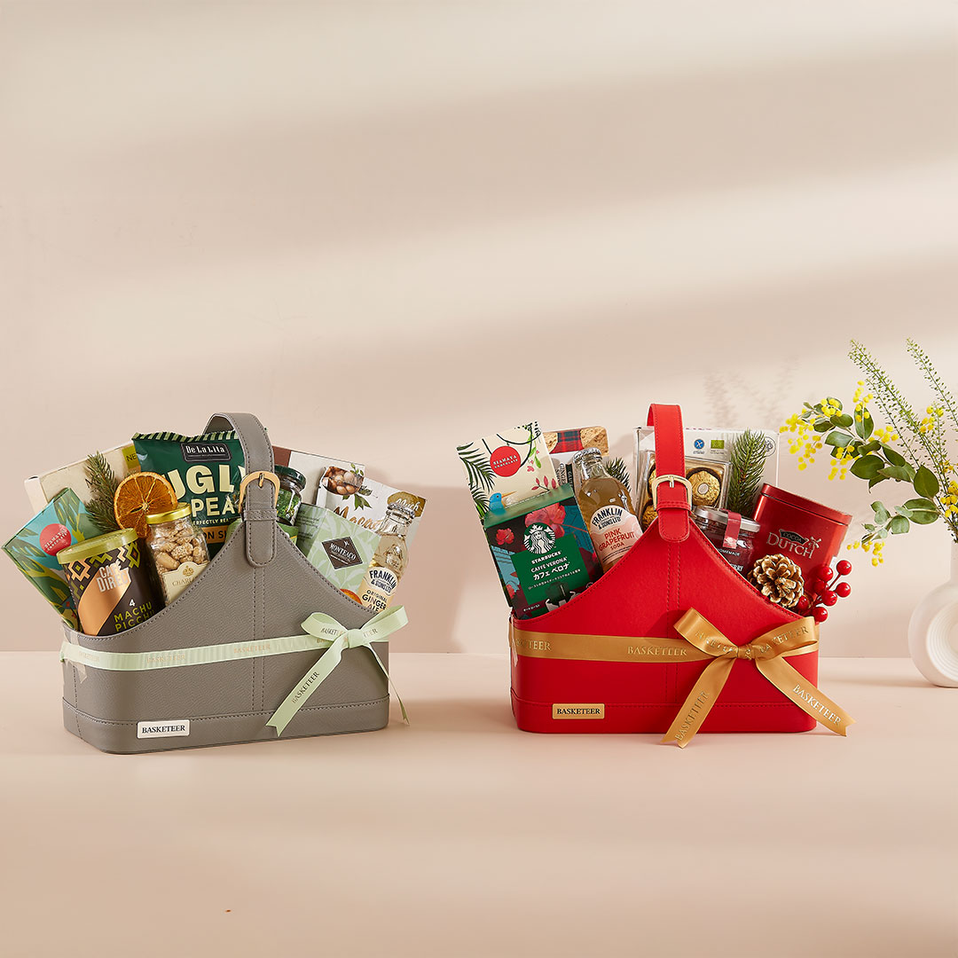 Premium leather gift baskets by Basketeer in grey and red, filled with gourmet snacks, cookies, drinks, and festive treats — designed for modern luxury gifting and New Year celebrations in Bangkok, Thailand.