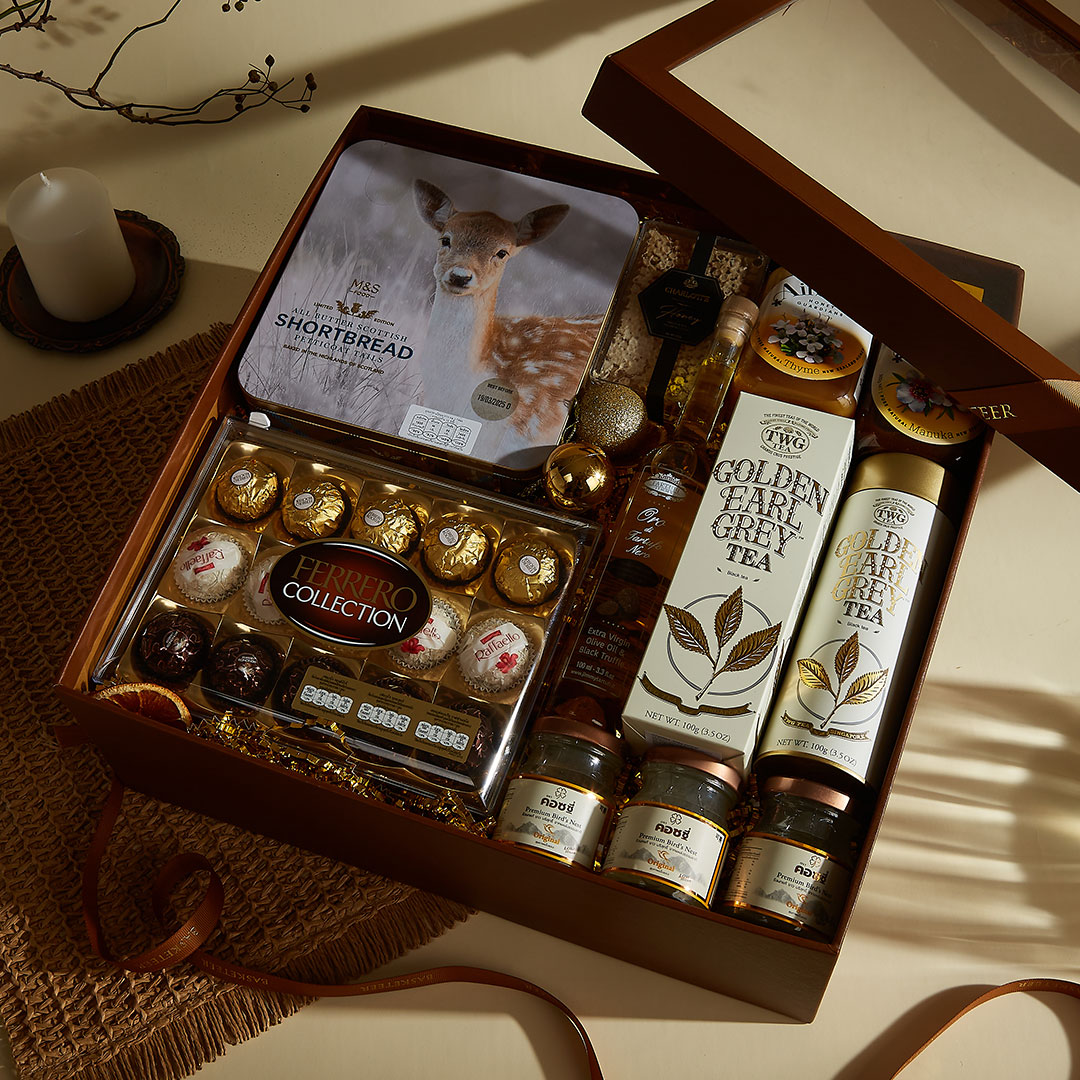 Luxury collection gift basket from Basketeer featuring premium chocolates, shortbread biscuits, TWG golden earl grey tea, artisanal honey, marmalade, and festive treats — beautifully arranged in a brown signature box, ideal for New Year gifting in Bangkok, Thailand.