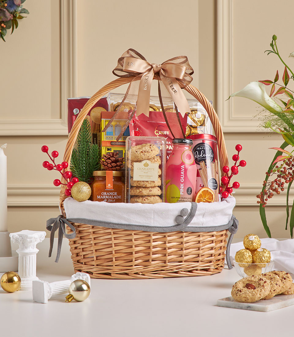 Golden gourmet gift basket with cookies, snacks, and festive treats.
