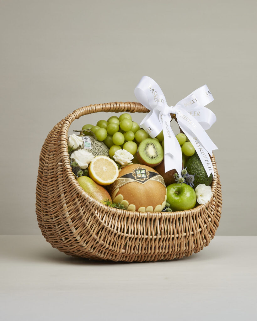 Luxury premium green fruit basket featuring melons, grapes, kiwi, pears, and apples by Basketeer Bangkok.