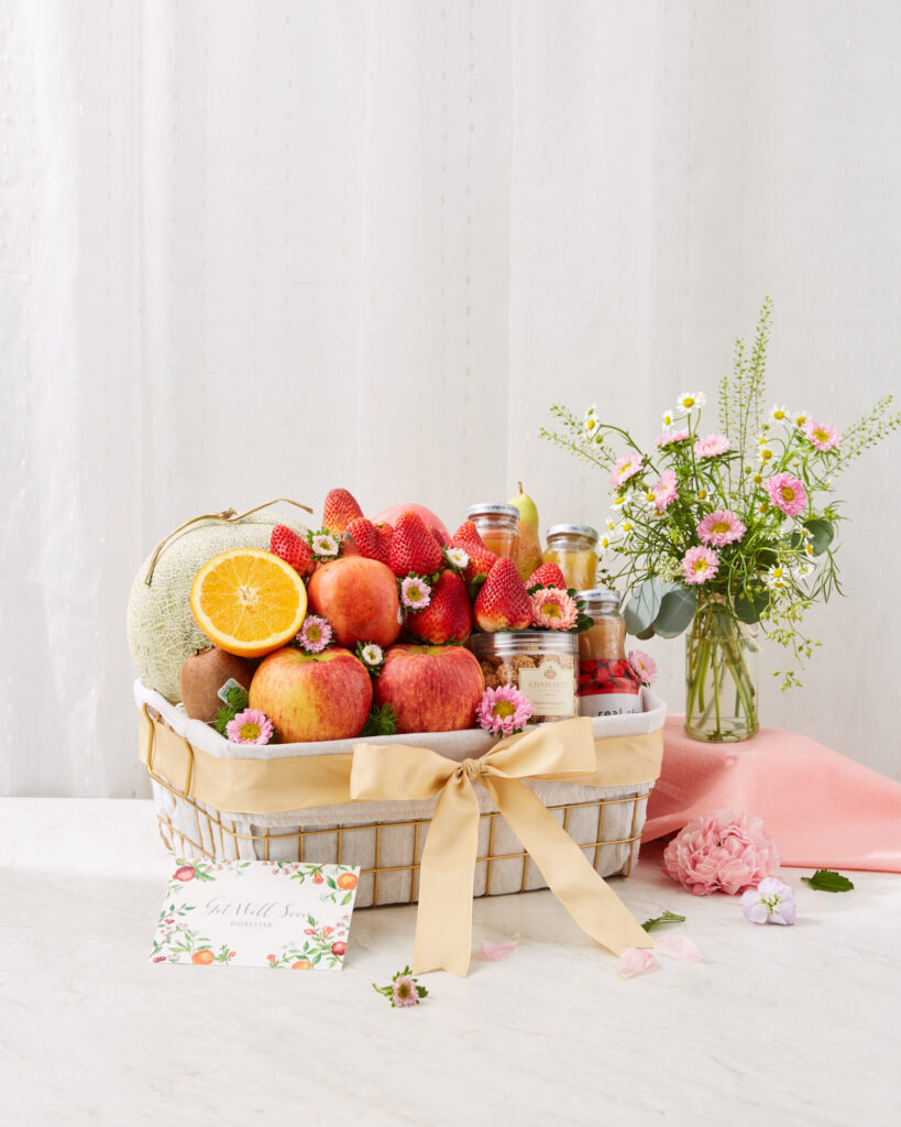 Luxury Get Well Soon fruit basket with premium apples, strawberries, melon, pears, and wellness essentials from Basketeer.