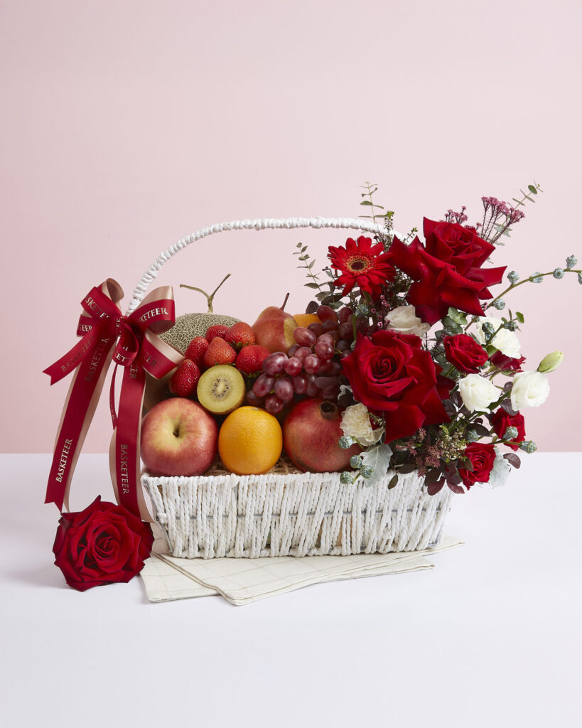 Premium birthday fruit basket with fresh fruits and red rose floral arrangement from Basketeer Bangkok.