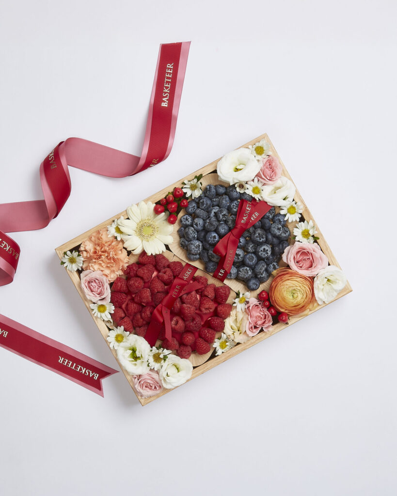 Premium thank-you berry gift box with raspberries, blueberries, and fresh flowers from Basketeer.