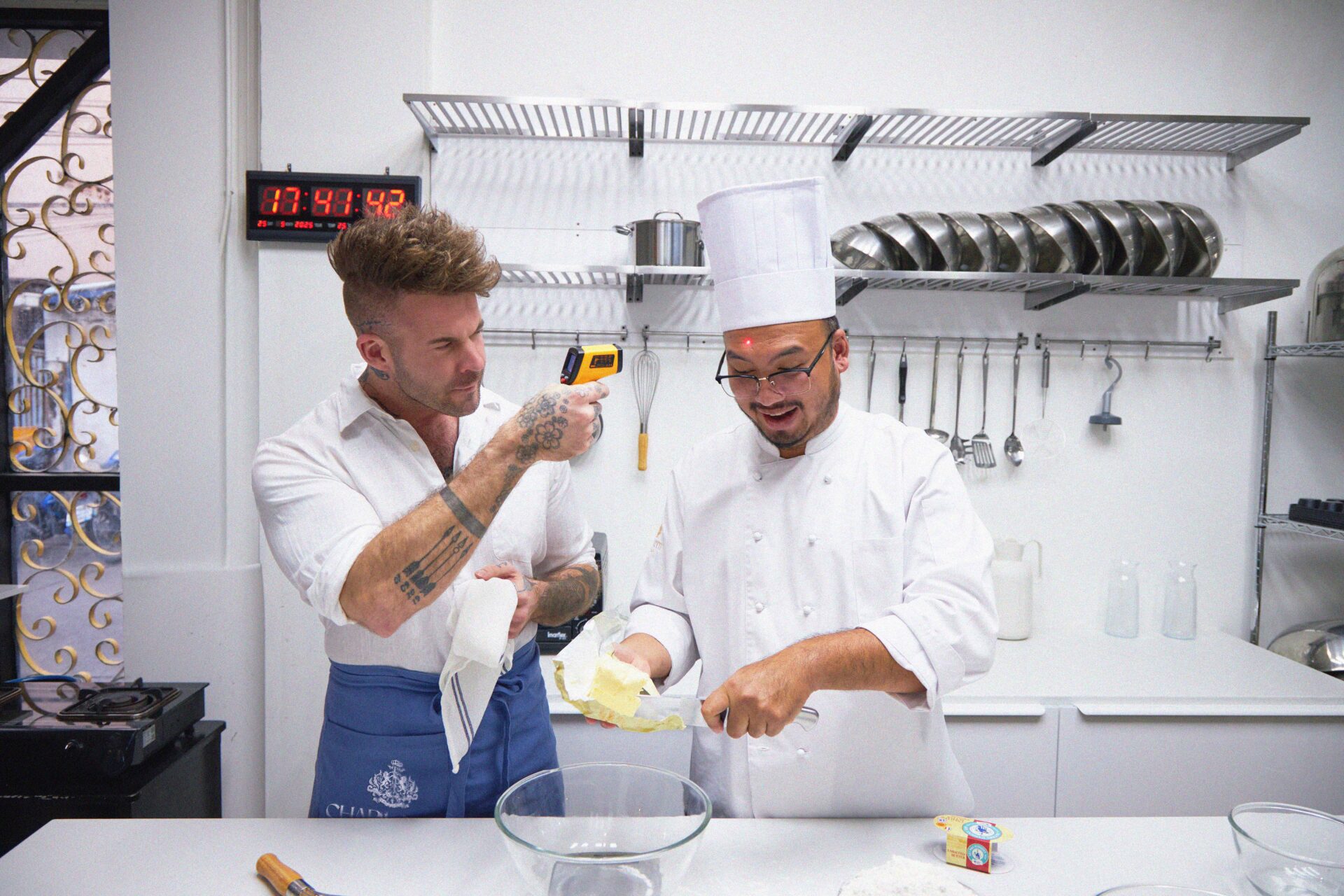 Dan Stoner, founder of Charlotte Bakery Bangkok, baking with a chef in the kitchen