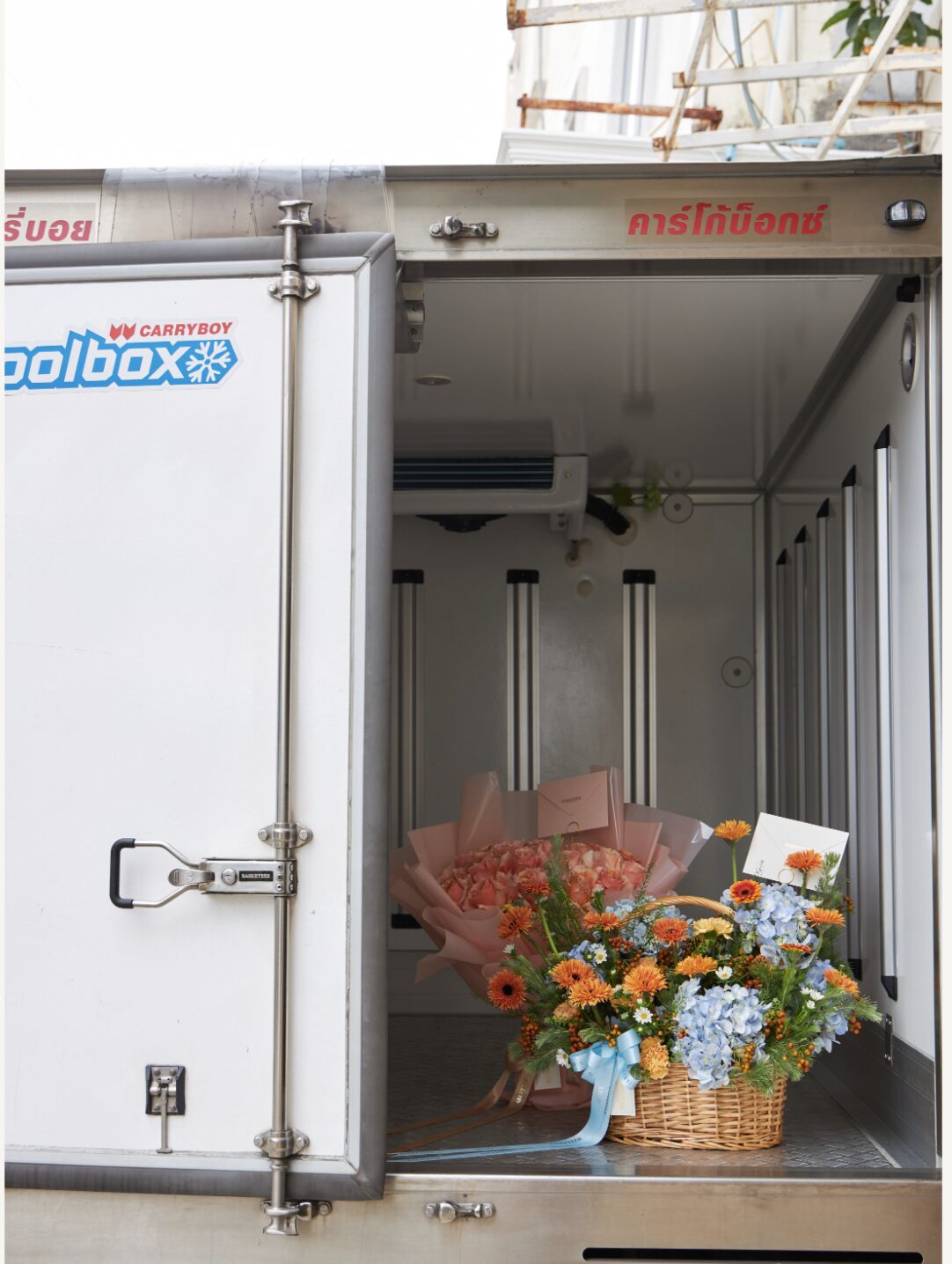 Fresh peach bouquet and pastel flower basket stored inside a temperature-controlled Flowers by Basketeer delivery truck in Bangkok.